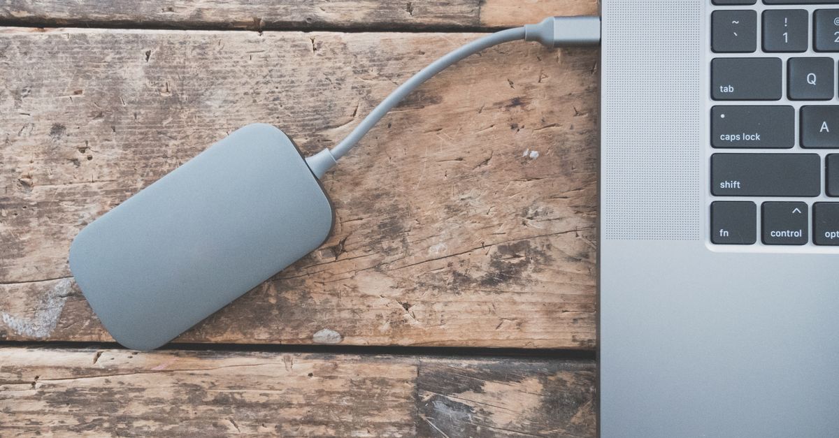 Offsite backup best practices: an external drive, a notebook checklist, and a cloud icon on a desk.